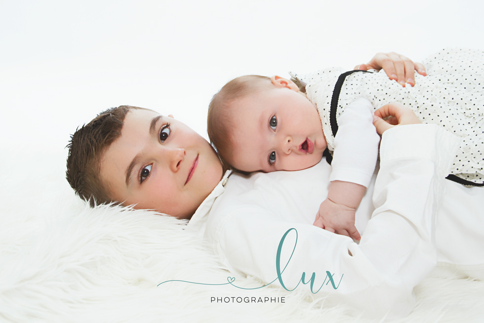Family photography montreal. Baby lying on boy's chest.