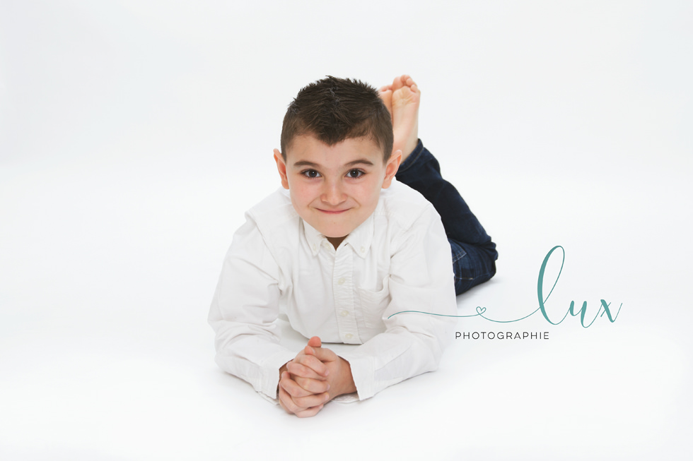 Family photography montreal. Boy lying on the floor.