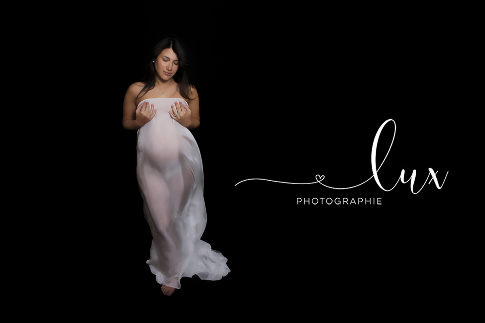 Montreal Maternity Photographer. Pregnant woman wraped in white scarf.