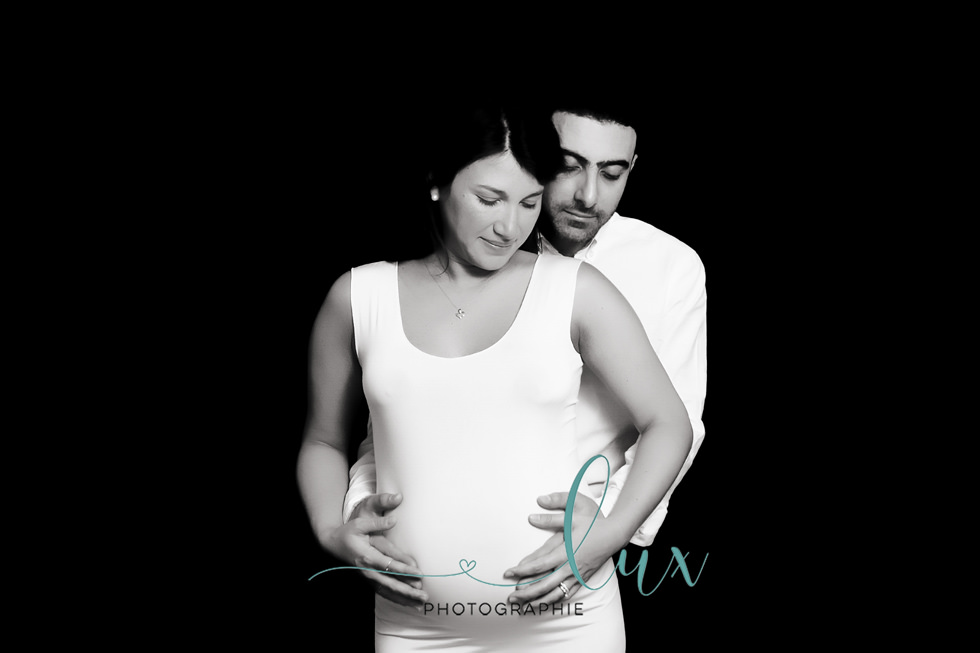 Montreal maternity photography. Man standing behind pregnant woman.