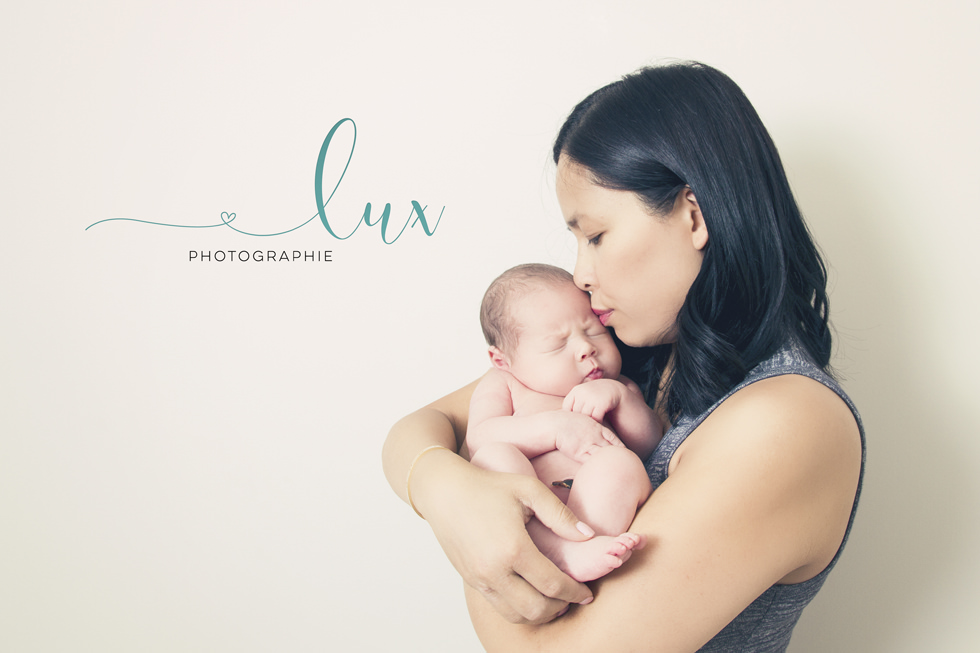 Montreal baby photography. Mother kissing newborn baby boy.