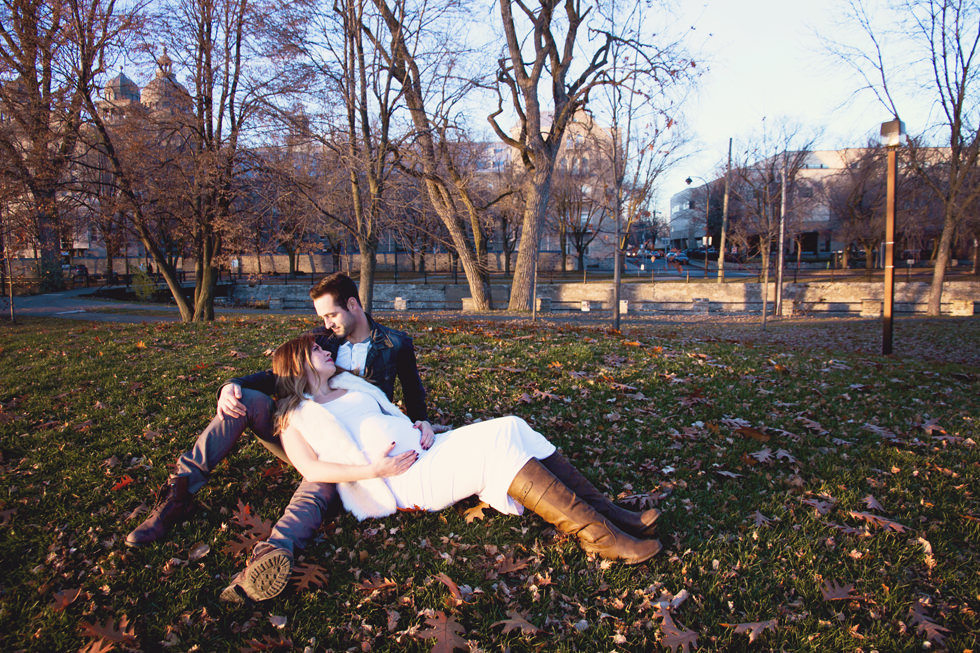 Montreal Maternity Photography. Man and pregnant woman lying in the grass.