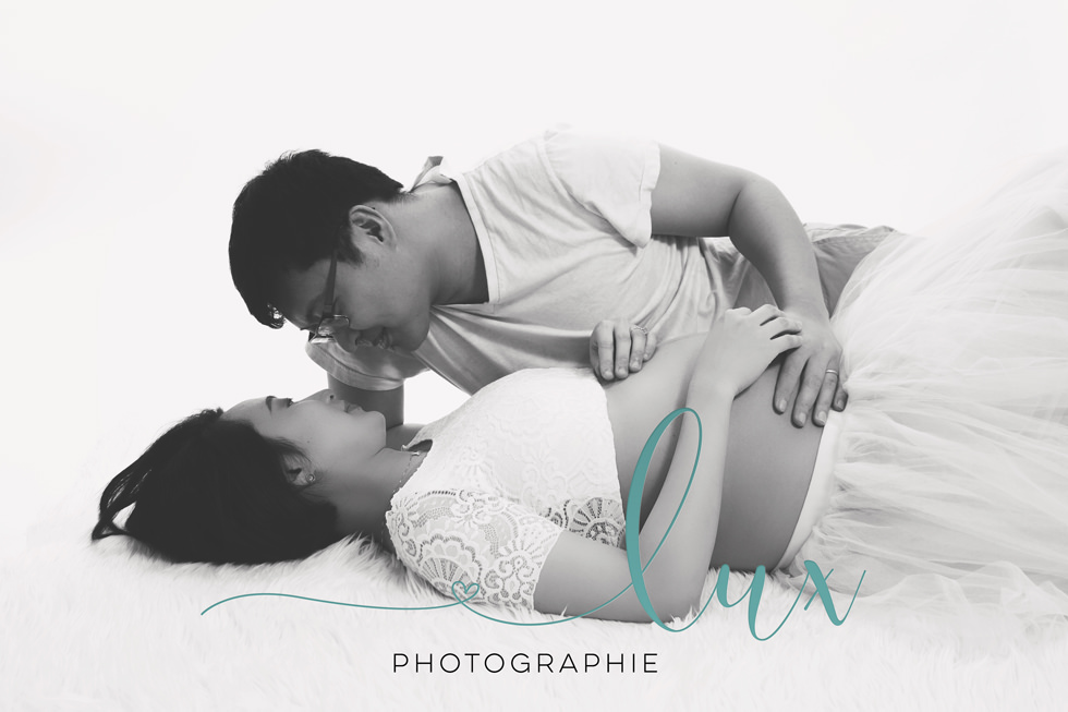 Pregnancy photography west-island. Man kissing pregnant woman.