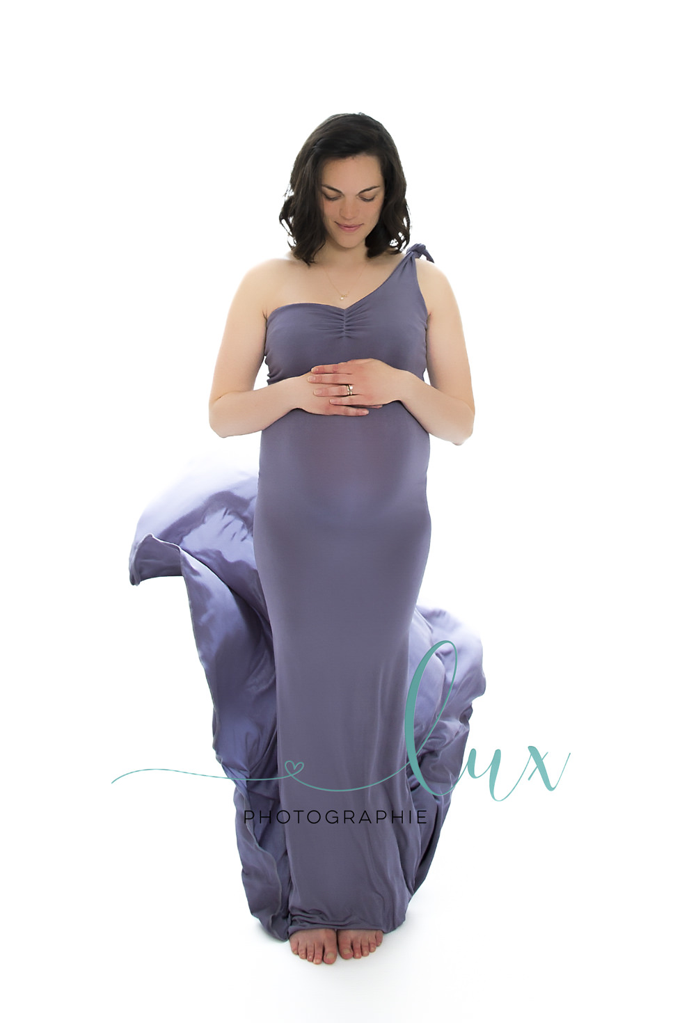 Pregnancy Photography Montreal. Woman posing is flowing gown.