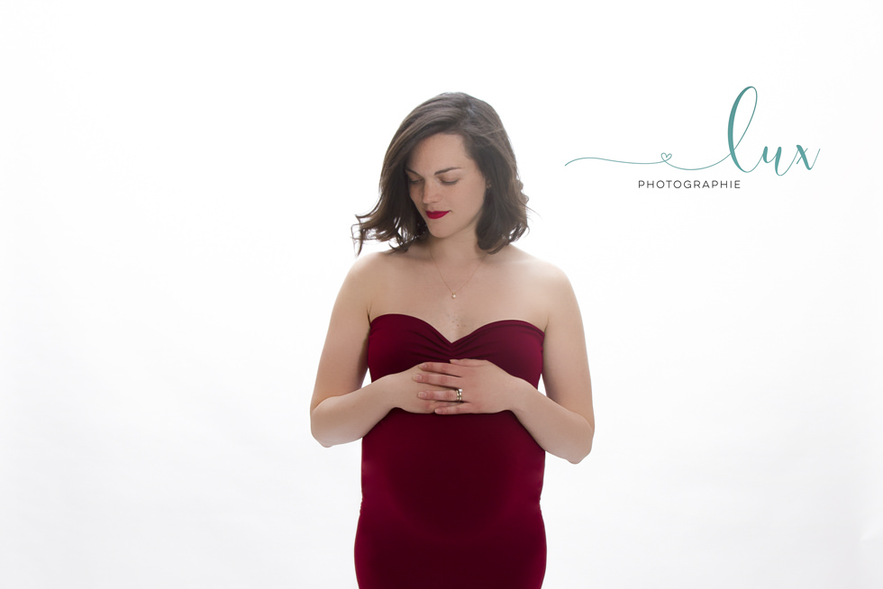 Pregnancy Photography Montreal. Woman posing in red gown.