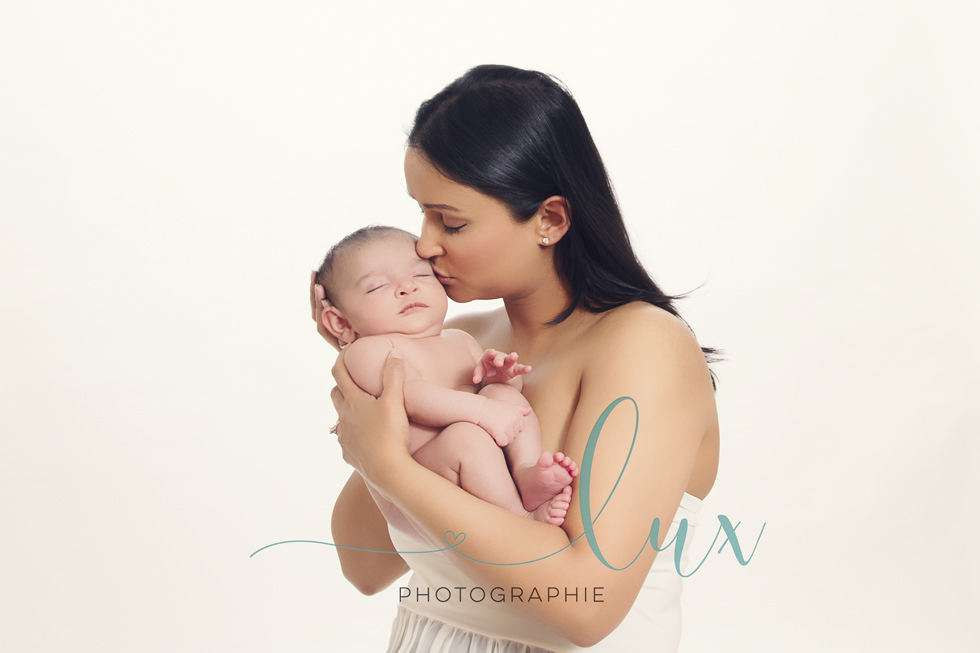 Baby photography Montreal. Woman kissing baby's cheek.