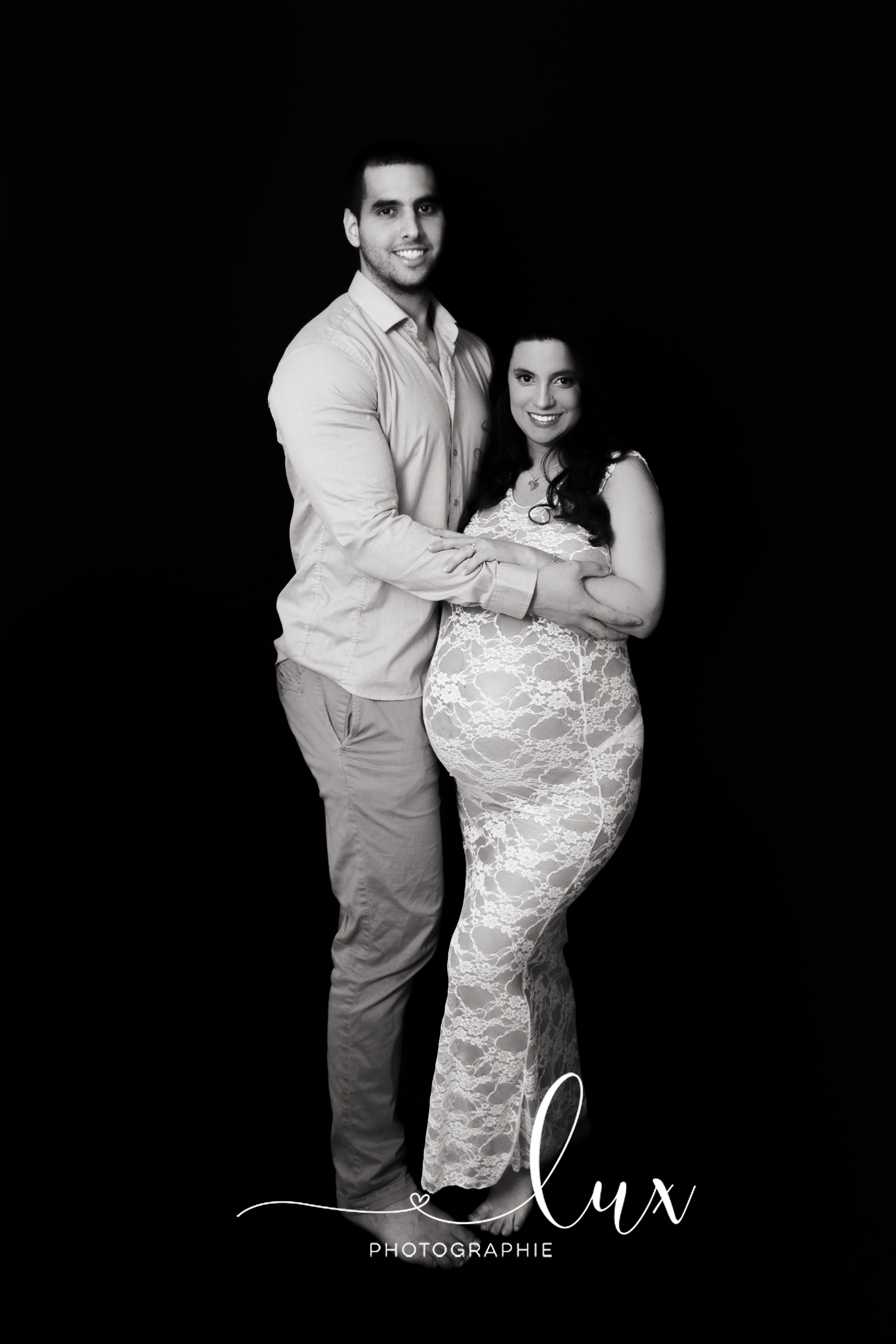 Montreal Maternity Photography. Man and pregnant woman looking at the camera.