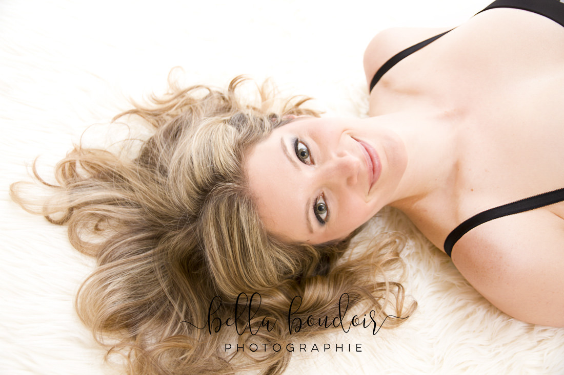 Boudoir photography Montreal. Face of woman lying on her back.