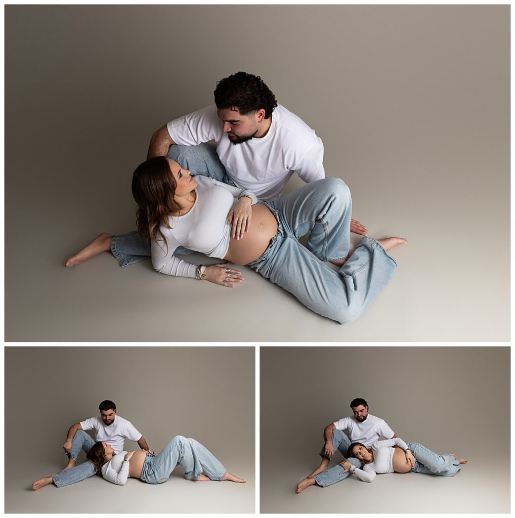 Maternity photoshoot capturing intimate couple moment sitting together in soft neutral tones